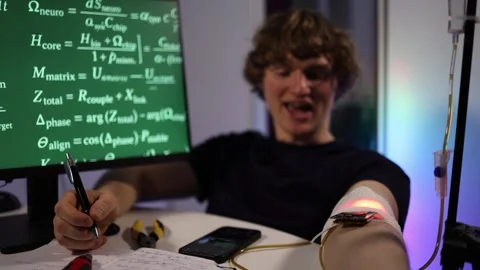 Student records results during biohacking wearable experiment Stock Footage 324443916