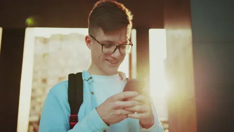 Student rejoicing while chatting with his classmates. Video portrait of young Stock Footage 141557550