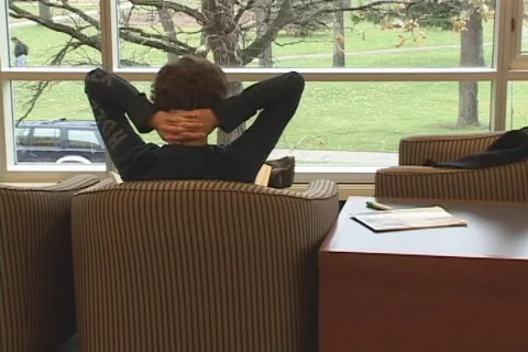 Student relaxing in library Stock Footage 548968