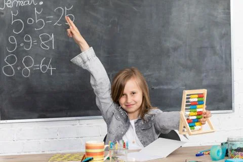 The student reports to answer in class to answer the teacher's question. Stock Photos