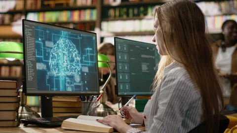 Student research AI brain visuals on desktop computer while reading books Stock Footage 337231021
