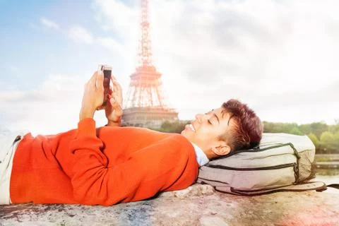 Student resting after college, using smart phone Foto stock
