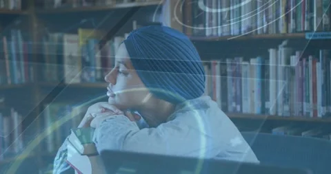 Student resting chin on hands while glancing left and activating holographic Stock Footage 327849370