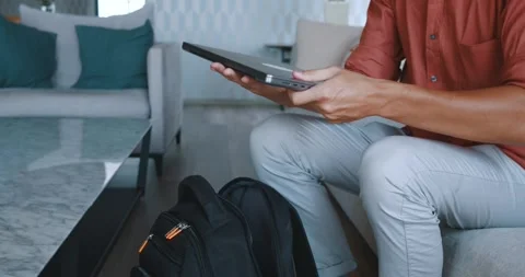 Student retrieves laptop from backpack ready for university homework. For Stock Footage 259842224