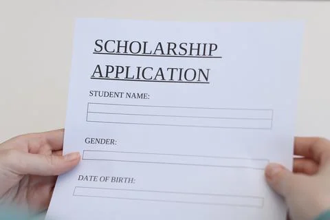 Student with scholarship application forms at white table, closeup Stock Photos
