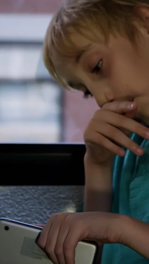 A Student on school bus on his device driving home from class Stock Footage 337220139