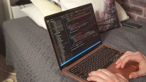 A student scrolls past code for website development on a laptop computer Stock Footage 205190434