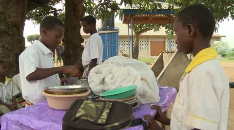 STUDENT SERVING LUNCH TO ANOTHER STUDENT AT SCHOOL Stock Footage 60626110