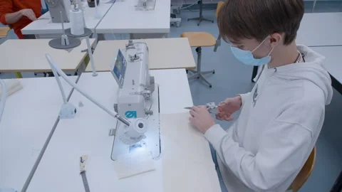 Student on a sewing machine at school - Slowmotion 25 Stock Footage 162474258