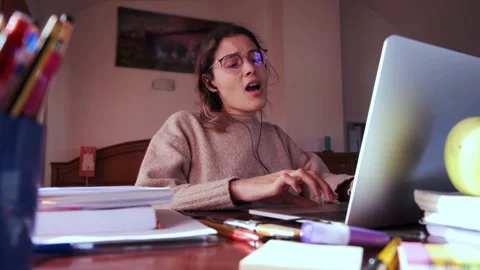 Student singing meanwhile she is using her laptop. Stock Footage 145811383
