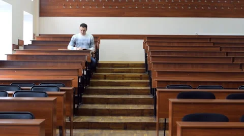 The student sits at the desk in the lecture hall Stock Footage 62597194