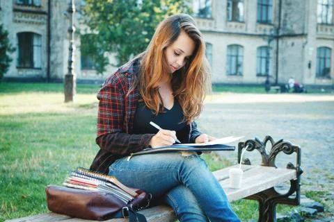 The student is sitting on the bench Stock Photos