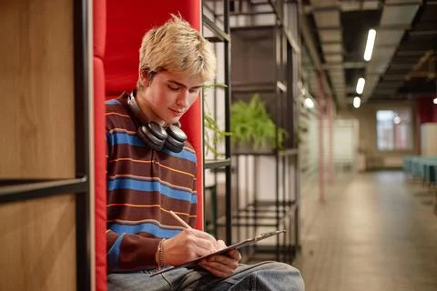 Student Sitting in Lounge Booth Stock Photos