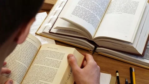 Student sitting at the table with books top view 스톡 동영상 155963075