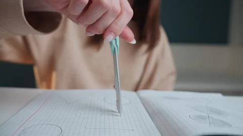 Student sketches geometry with compass. Student engages in detailed compass and Stock Footage 341977444