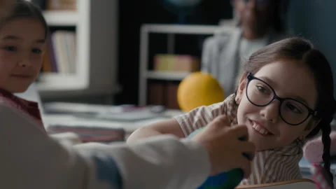 Student Smiling while Sharing Planet Model with Classmate in Astronomy Class Stock Footage 311542350