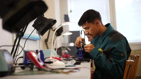 Student Soldering Electronic Components in Technical Workshop Stock Footage 306682576