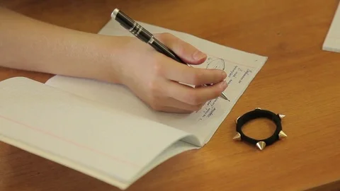 The student solves the equation in notebook 스톡 동영상 72197487