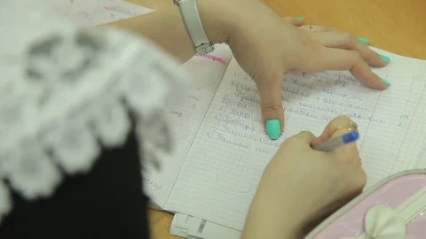 The student solves equations  in the notebook Stock Footage 72196974