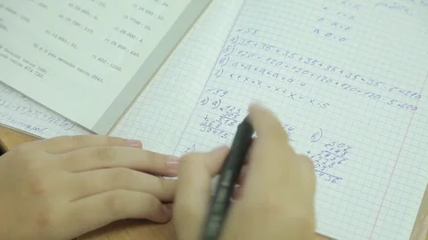 The student solves equations  in the notebook Stock Footage 72197012
