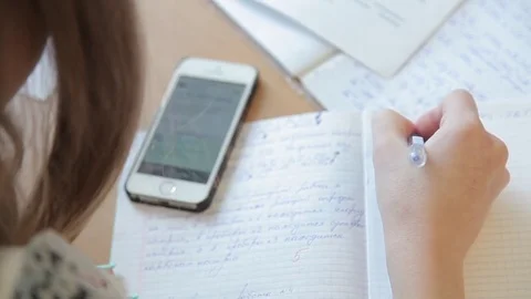 The student solves equations  in the notebook Stock Footage 72197265