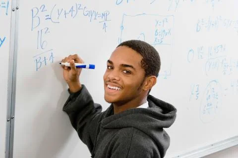 Student Solving Algebra Equation On Whiteboard Stock Photos