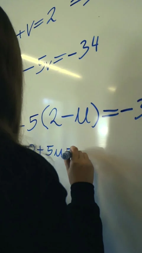 Student solving algebra equations on classroom whiteboard Stock Footage 345550798