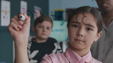 Student Solving Math Problem on Transparent Classroom Board Stock Footage 312059290