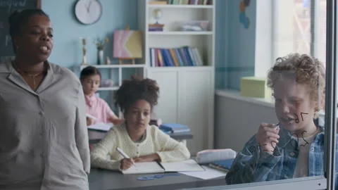 Student Solving Math Problems at Transparent Board in Class Stock Footage 312055784