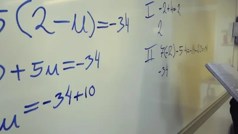Student solving a mathematical equation on a whiteboard Stock Footage 345480020