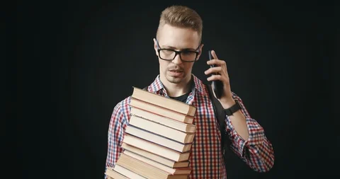 Student With Stack Of Books Talking on Phone Stock Footage 122938580