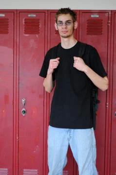 Student standing in front of lockers Stock Photos