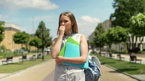 Student standing on the pathway and looking very worried Stock Footage 67379187
