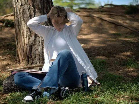 Student stretching during a study break in the park Foto stock