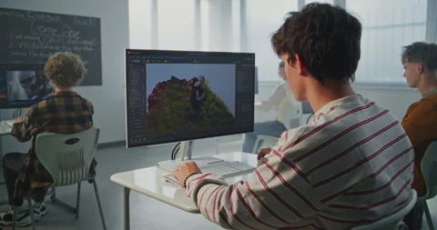 Student in Striped Sweatshirt Creates 3D Animation on Computer in Modern Stock Footage 318524712