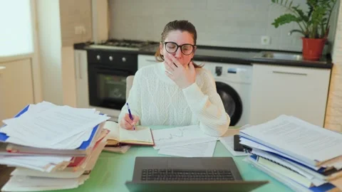 Student Studies Intensely at Home With Piles of Papers Around Her Stock Footage 327905665