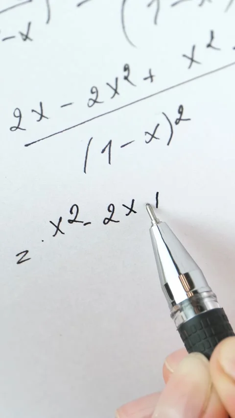Student studies math equations with pen. Close-up of hand writing solutions on Видео 344998535