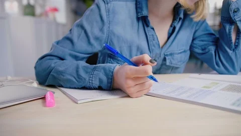 Student studies in school library for final exam very diligently reading book Stock Footage 103291034