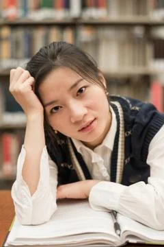 Student studying at a desk in library Stock Photos