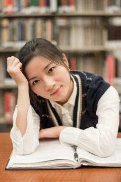Student studying at a desk in library Stock Photos