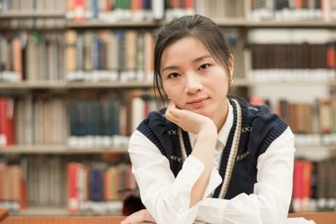 Student studying at a desk in library Stock Photos
