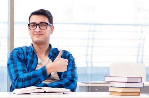 Student studying in the empty library with book preparing for ex Stock Photos