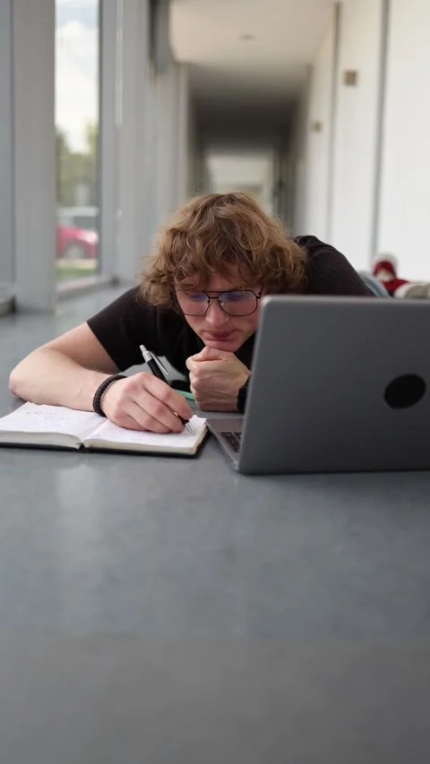 Student studying on the floor Stock Footage 337850984
