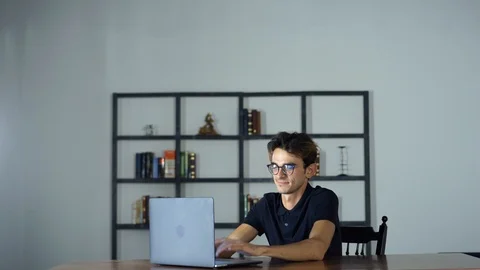Student studying with laptop and taking notes on a desktop at home Stock Footage 93238075