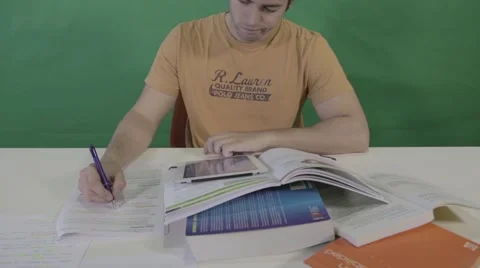 Student studying in library with books and iPad (with green screen background) Stock Footage 46263440