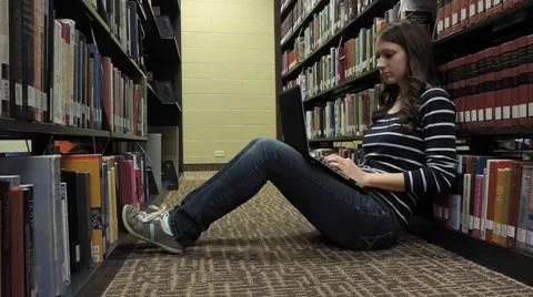 Student studying at library Stock Footage 46947762
