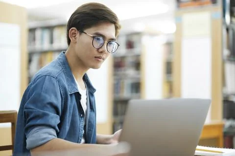 Student studying at library. Stock Photos