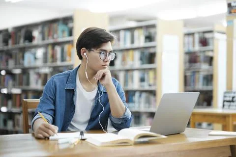 Student studying at library. Stock Photos
