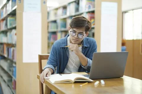 Student studying at library. Stock Photos