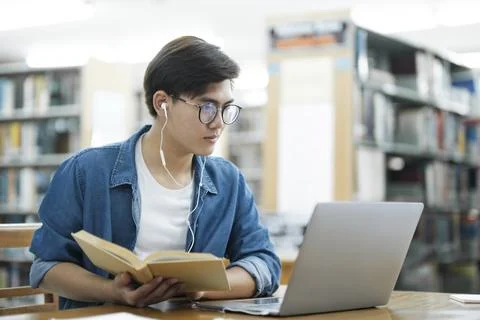 Student studying at library. Stock Photos